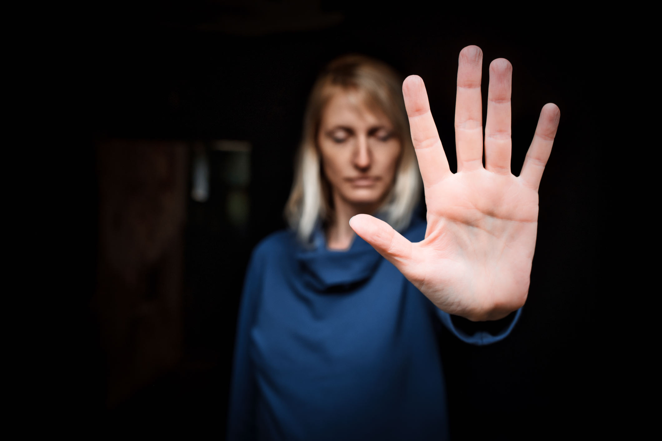 woman with her hand out signifying "stop"