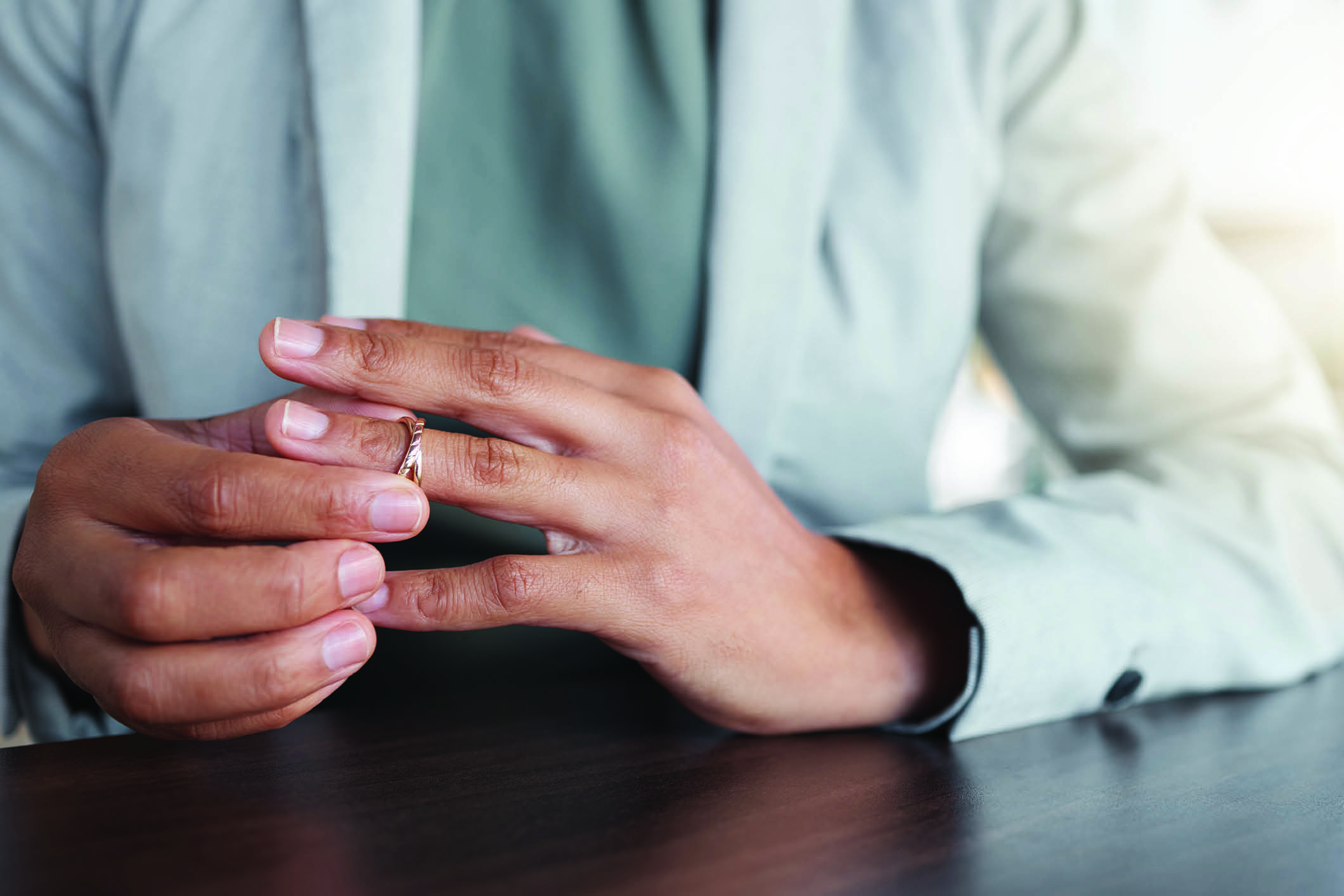 person removing their wedding ring - image for a blog post about collaborative divorce